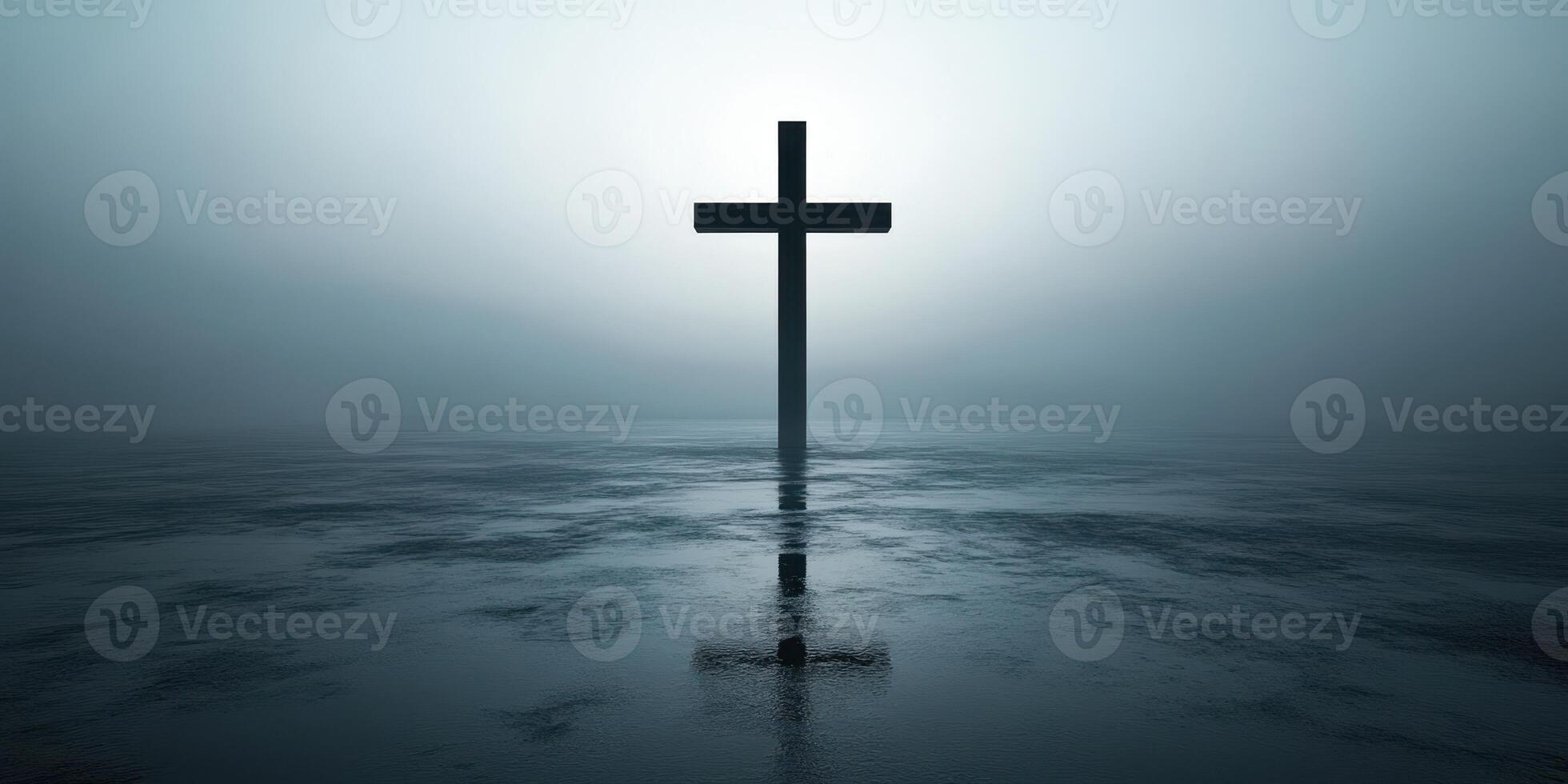 Dark silhouette of a cross reflecting in still water during foggy dawn near a tranquil landscape photo