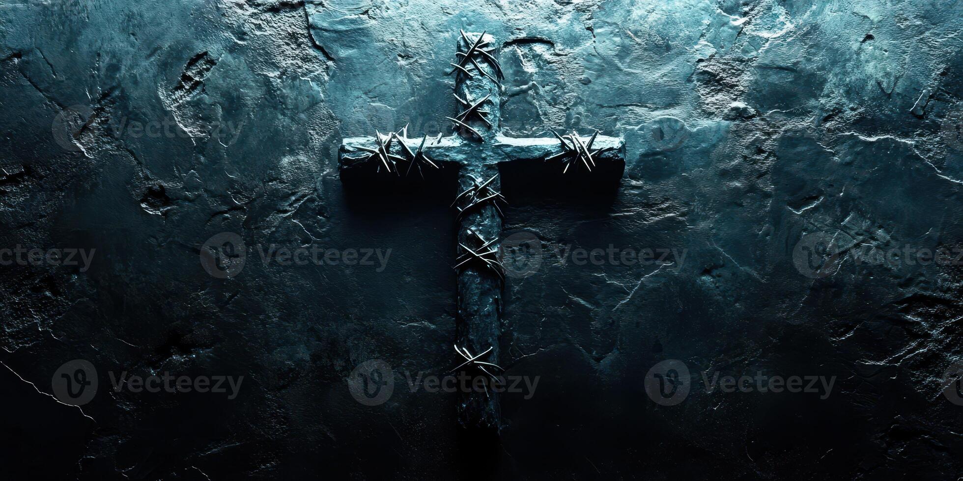 Dark crucifix entwined with thorns on a textured stone surface illuminated by moody lighting photo