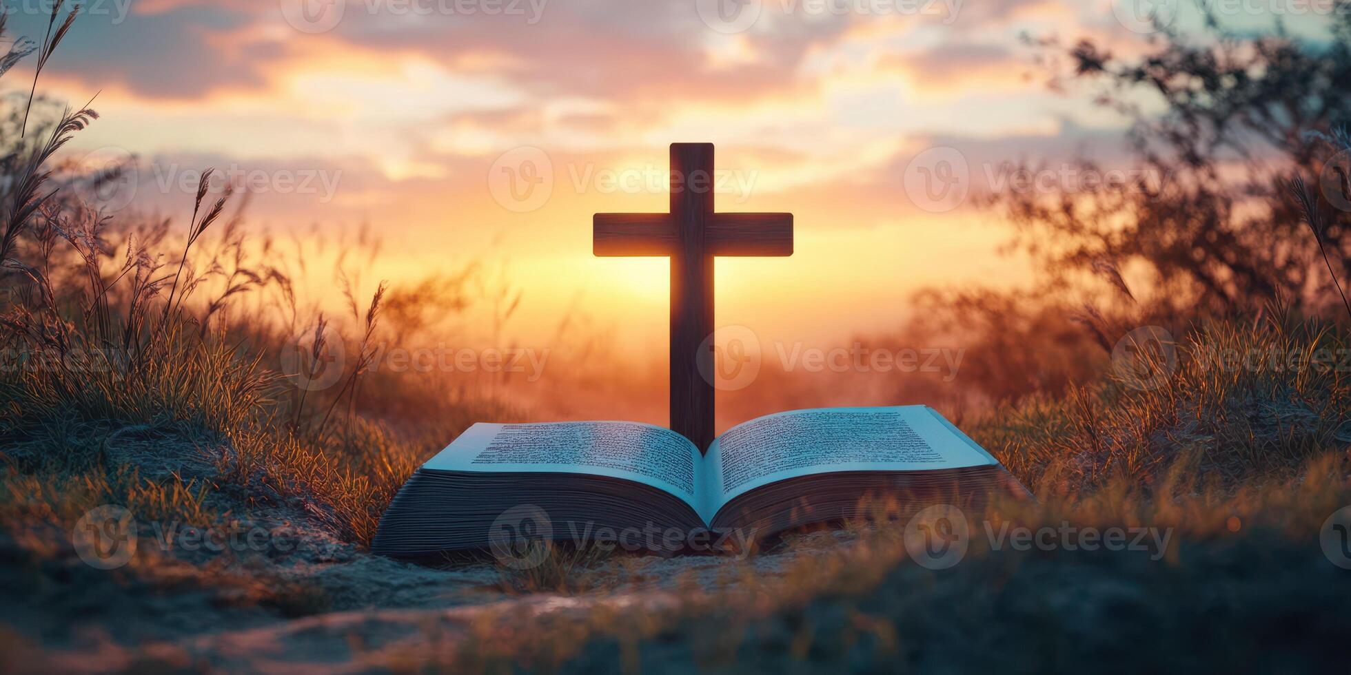 Cross placed on an open Bible during a peaceful sunset in a natural setting photo