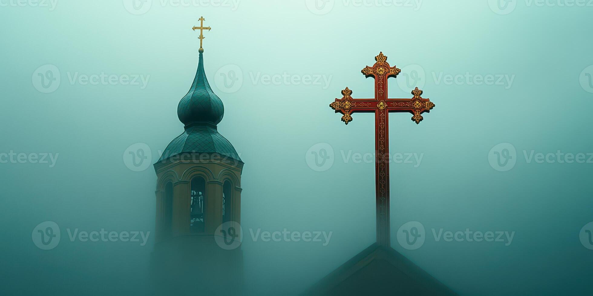 Fog envelops a church tower and cross, creating a serene and mysterious atmosphere at dawn photo