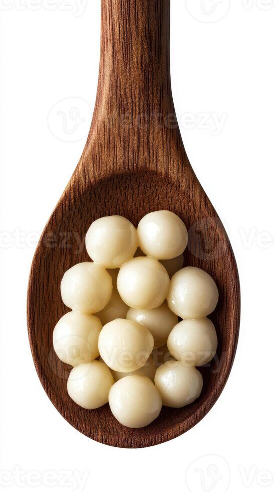 Delicious white dough balls in a wooden spoon ready for cooking or serving at home or events photo