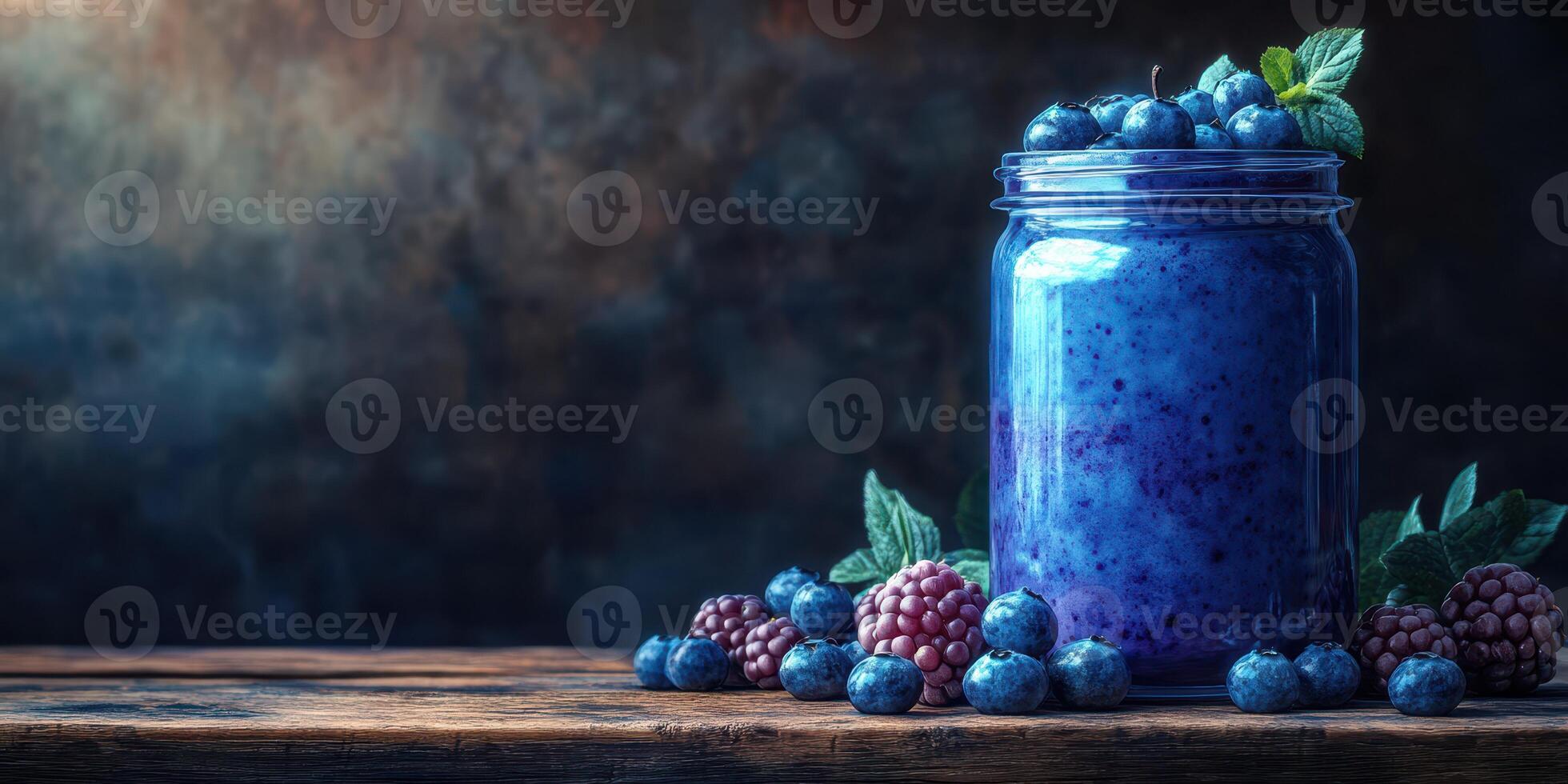 Freshly prepared berry smoothie in a jar displayed on rustic wooden table with vibrant blueberries and blackberries photo