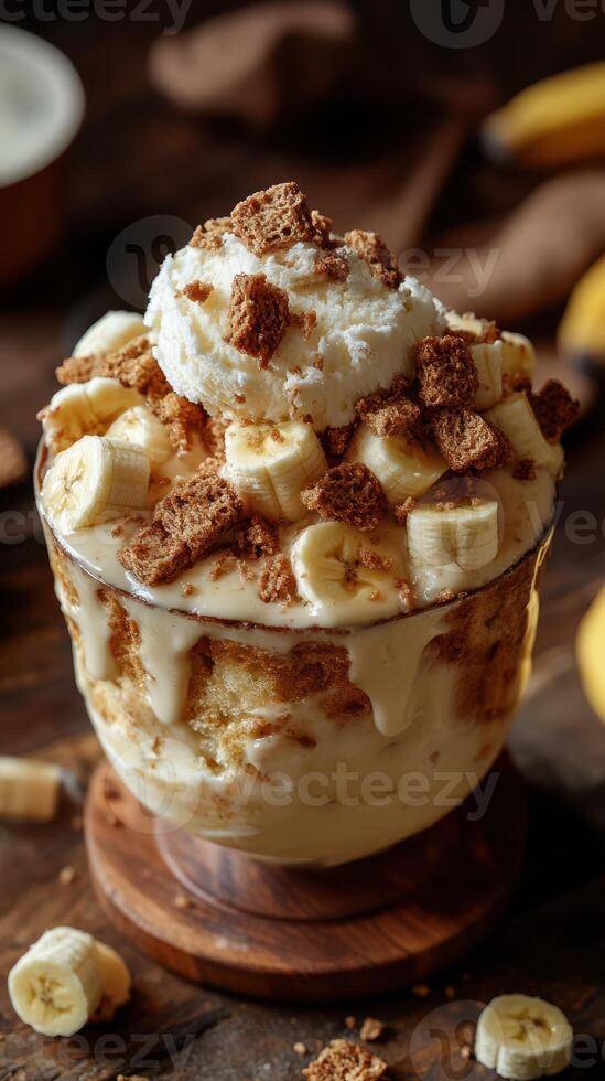 Delightful dessert with layers of creamy banana and crunchy toppings served in a glass bowl photo