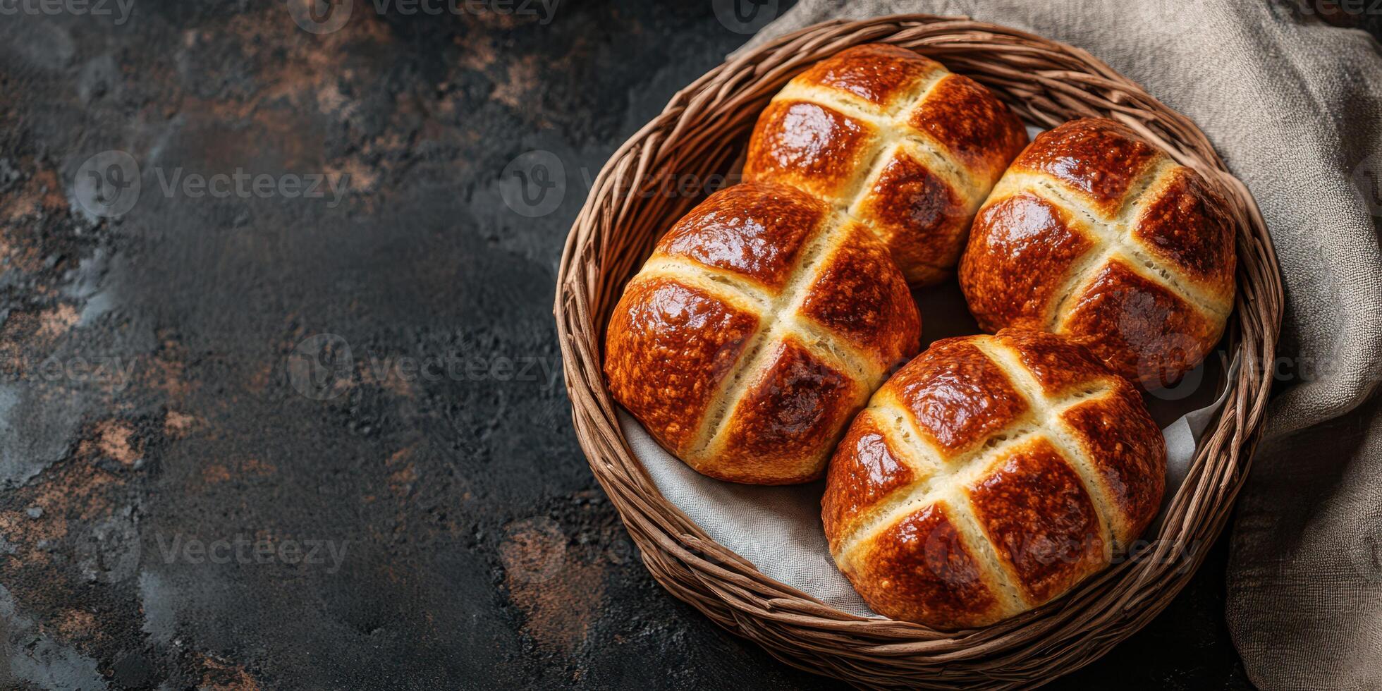 Freshly baked hot cross buns arranged in a cozy wicker basket on a rustic table photo