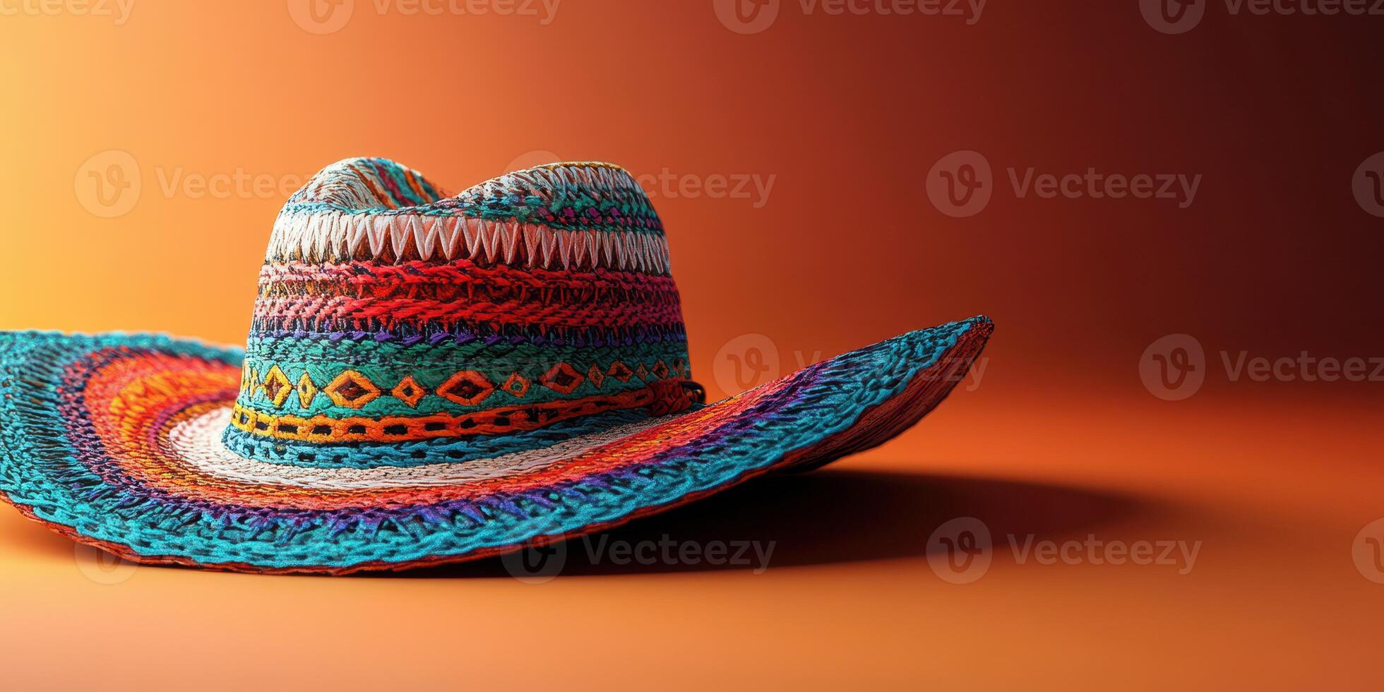 Colorful woven sombrero resting on an orange background in artistic display highlighting craftsmanship and design photo