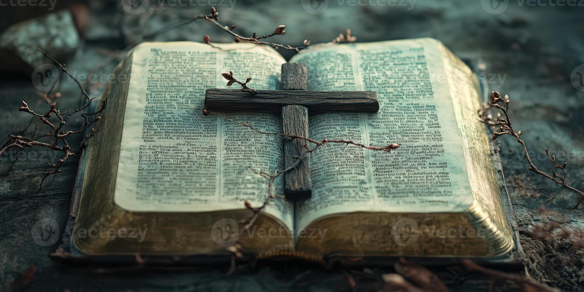 Old book with a wooden cross resting on it, surrounded by twigs and natural elements in a tranquil setting photo