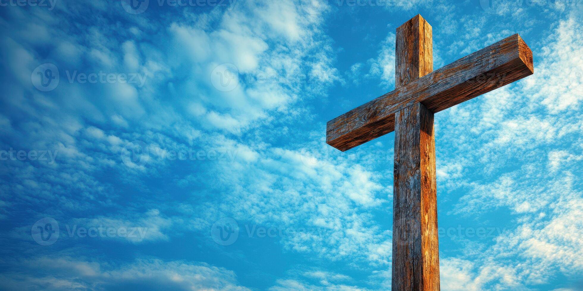 Rustic wooden cross stands tall against a vivid blue sky with fluffy clouds in a serene landscape photo