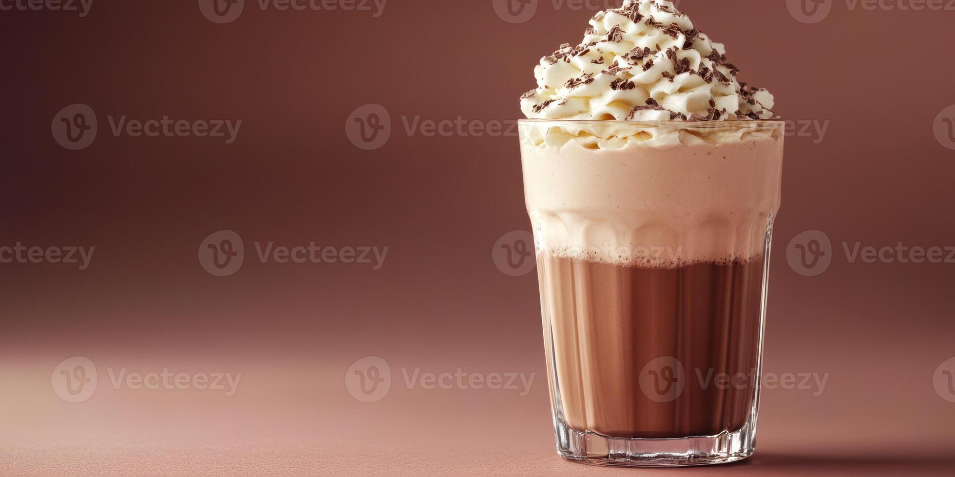 Indulgent whipped cream topped chocolate drink served in a glass with chocolate shavings sprinkled on top photo