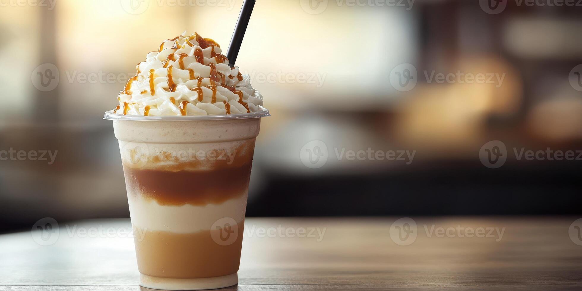 Refreshing caramel layered drink served in a clear cup on a wooden table in a cozy cafe setting photo
