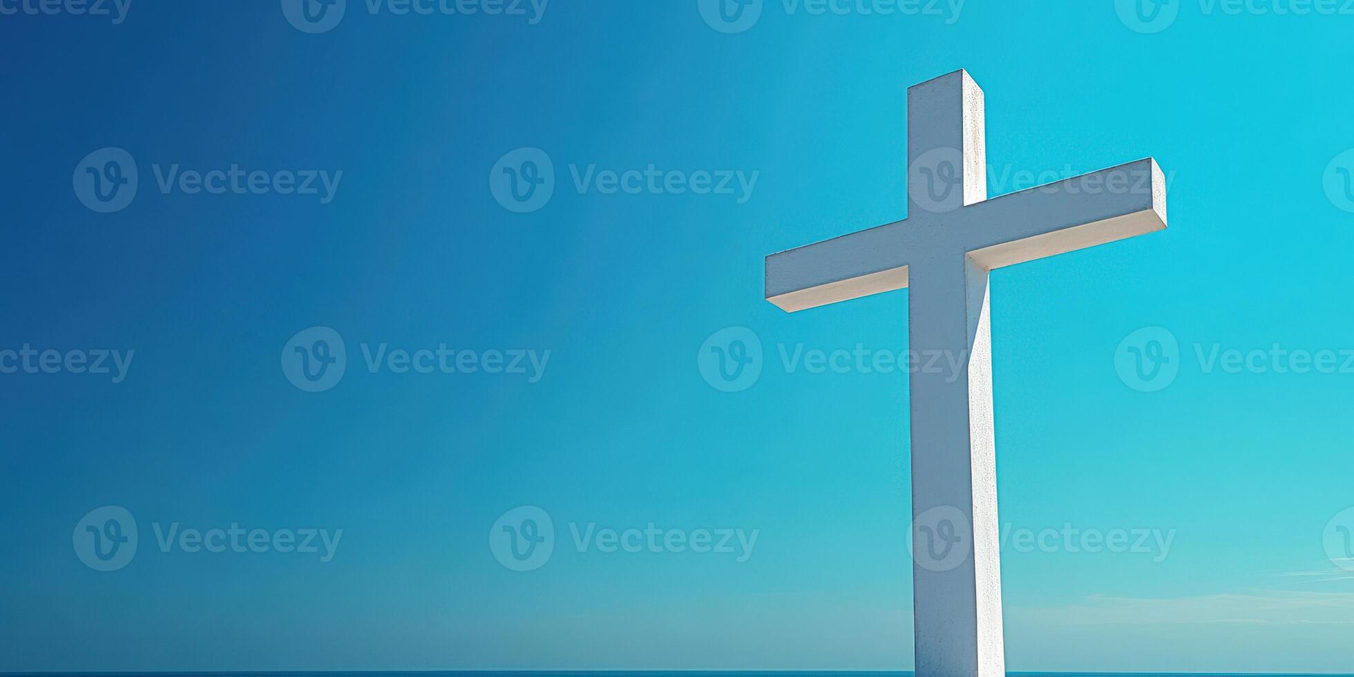 White cross stands against a clear blue sky over calm waters, symbolizing faith and hope on a serene day photo
