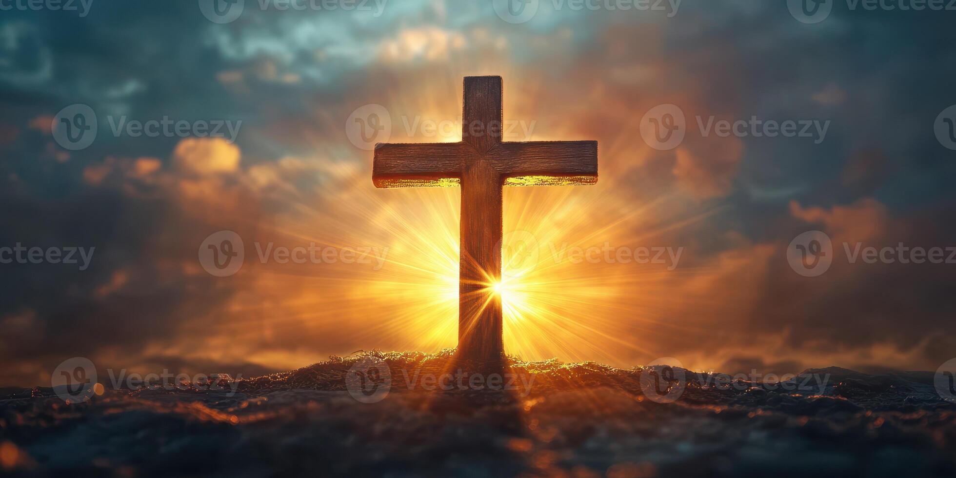 Cross illuminated by a radiant sunset against a dramatic sky highlighting faith and spirituality photo