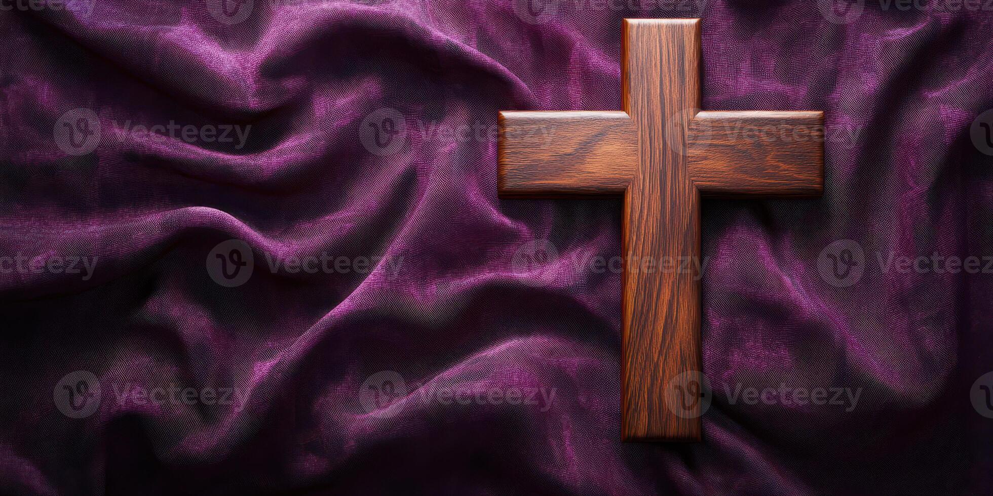Wooden cross placed on deep purple fabric symbolizes faith and devotion during a spiritual moment photo