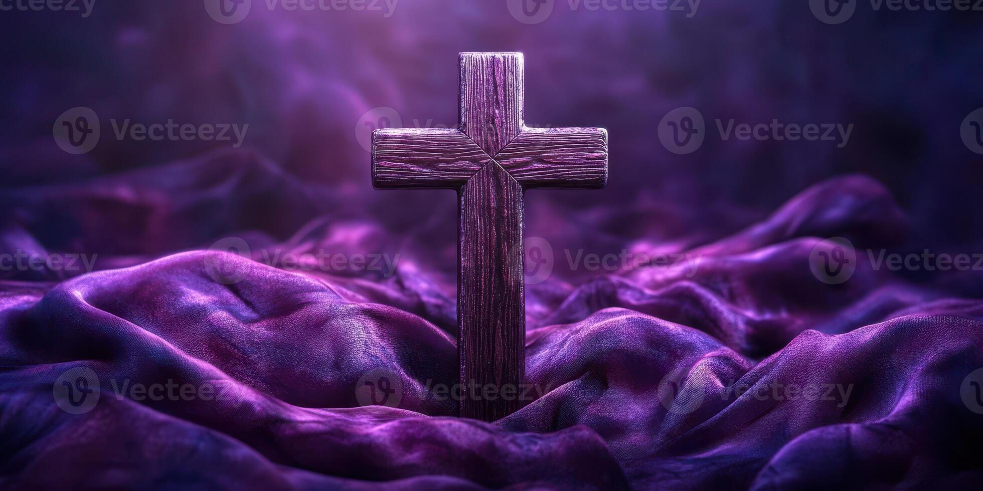 Wooden cross surrounded by deep purple fabric creating a spiritual atmosphere photo
