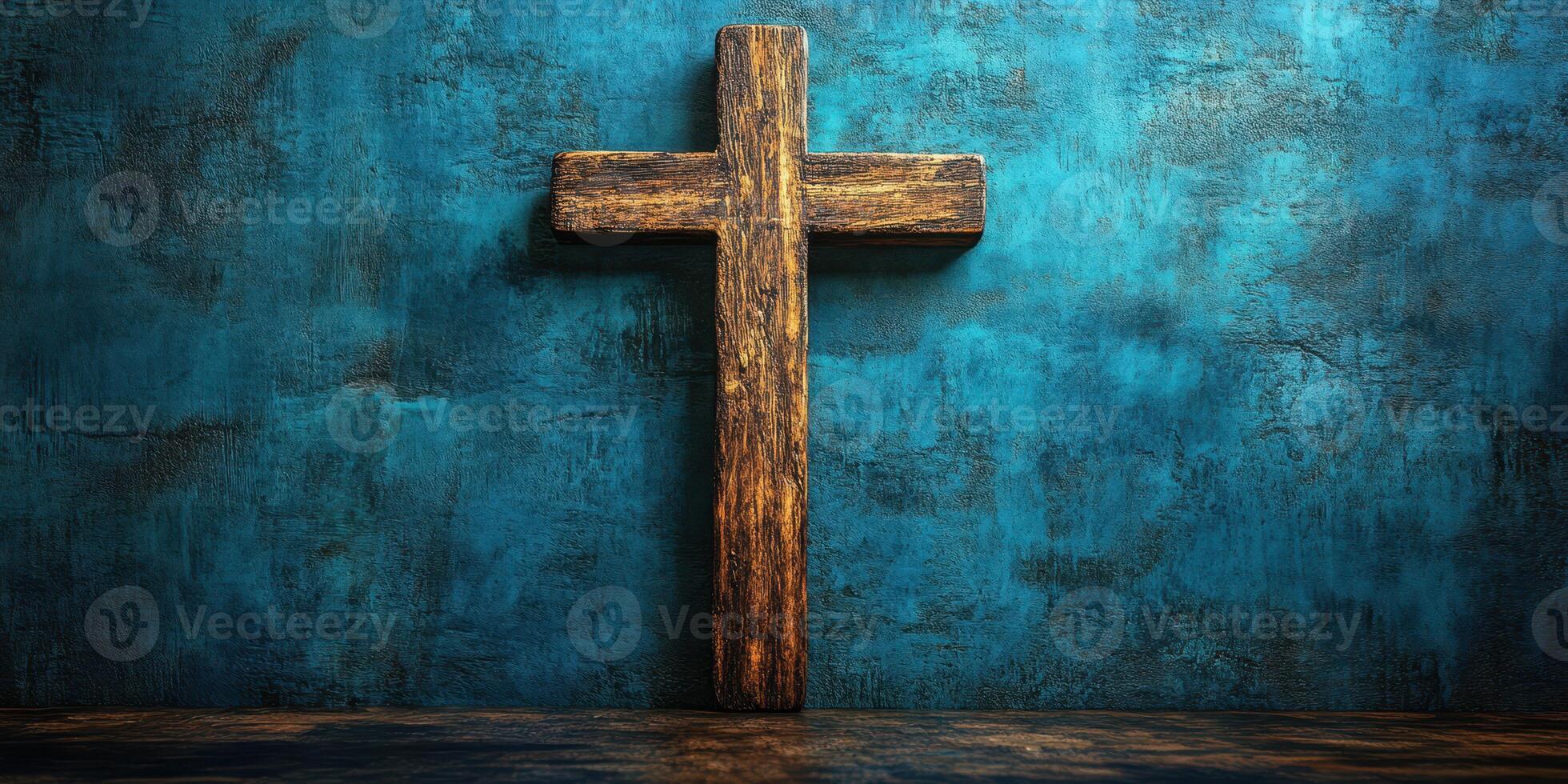 Wooden cross against a textured blue wall in a serene and reflective setting photo
