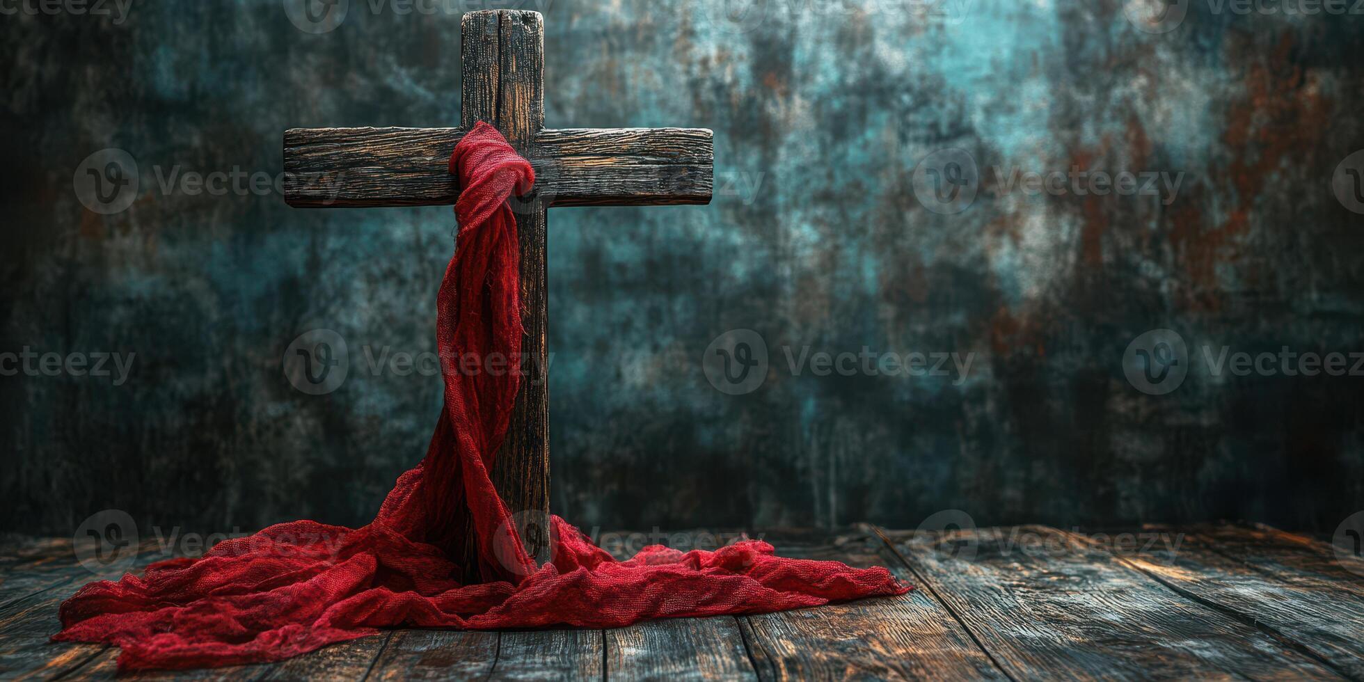 Symbolic wooden cross with a flowing red cloth against a textured backdrop in a calm setting photo