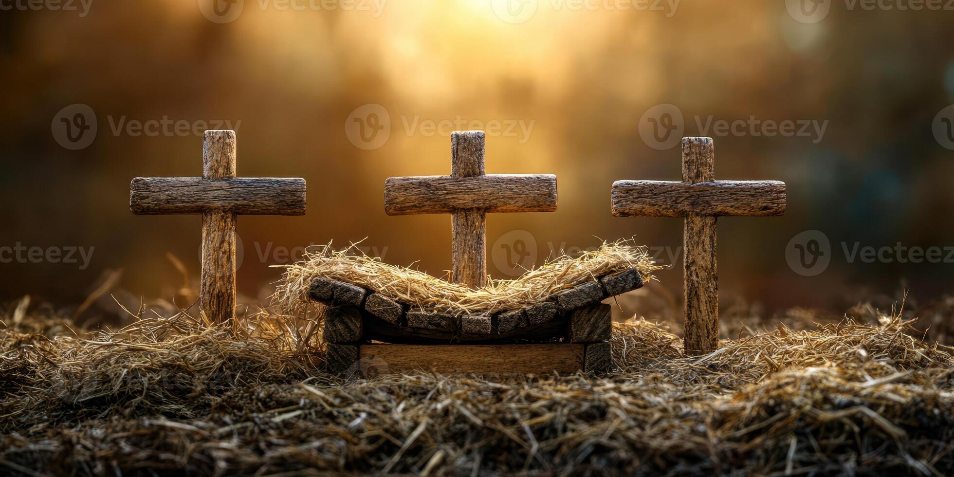 Rustic nativity scene featuring wooden crosses and a bed of straw at sunset photo