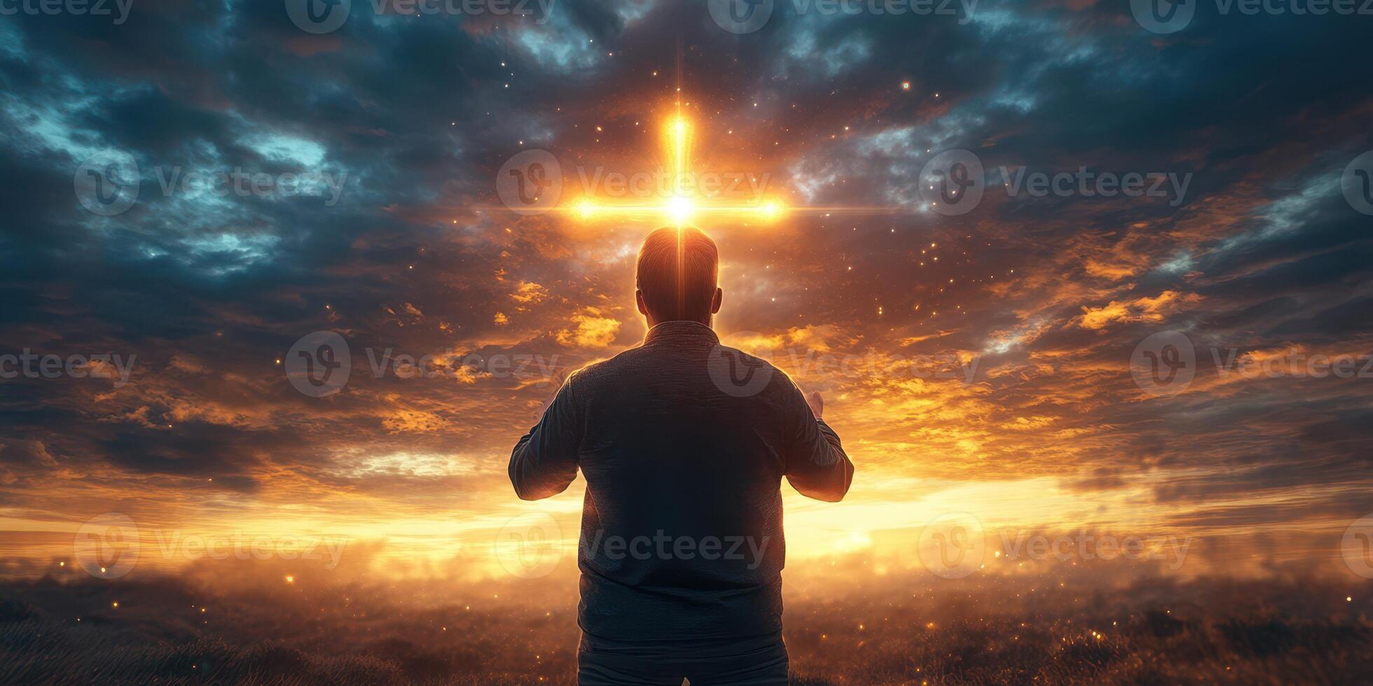 Man gazes at radiant cross in the sky during sunset in tranquil landscape photo