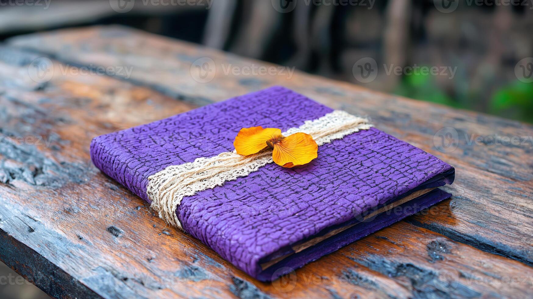 Purple textured journal with flowers rustic wooden table background wedding or gift concept photo