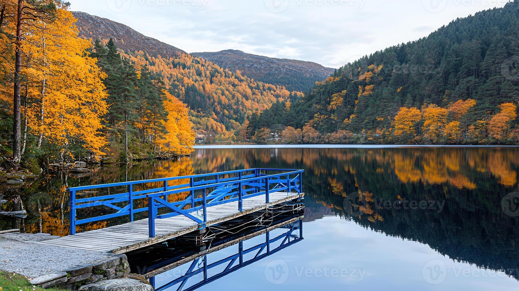 Serene Autumn Lake with Blue Wooden Dock and Colorful Foliage Reflection photo
