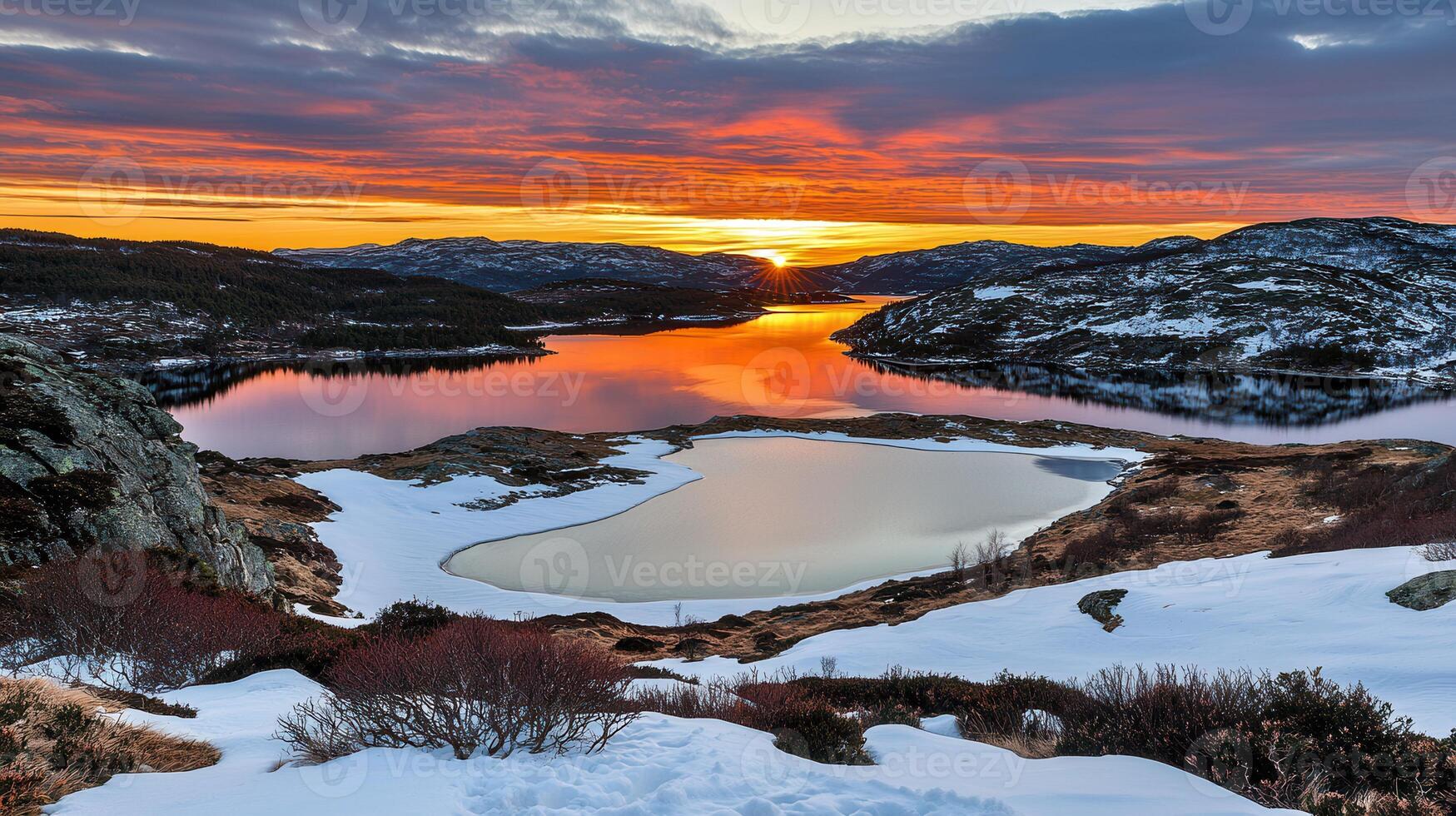 Stunning Sunset over Frozen Lake and Snowy Mountains in Winter Wonderland photo