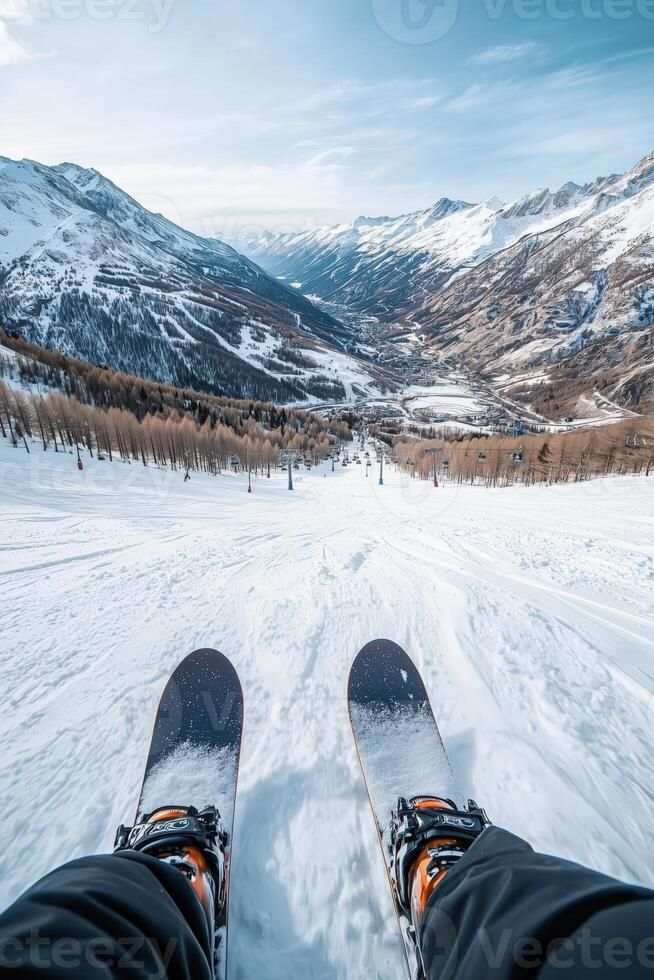 Skiing down a snowy mountain slope with alpine landscape in the background photo