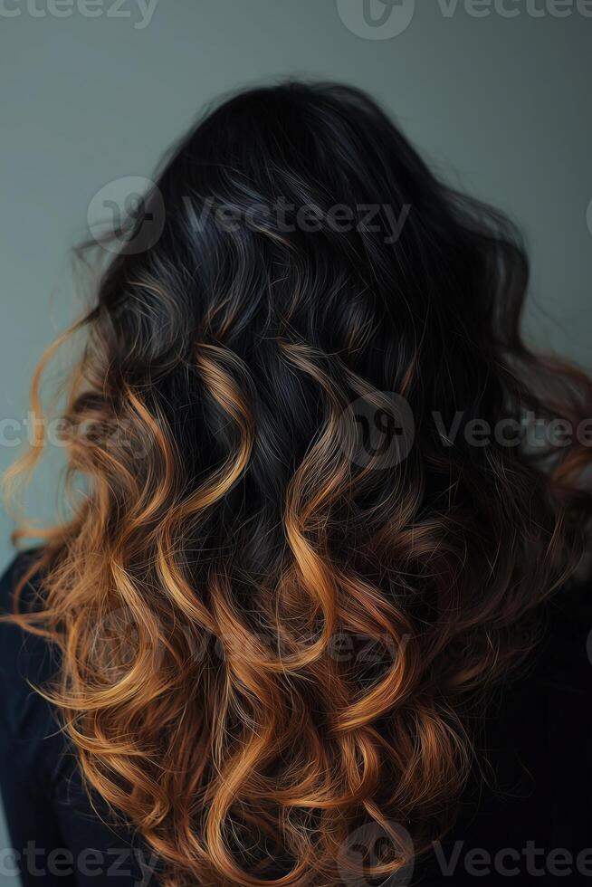 Beautiful woman with long wavy hair featuring a stunning gradient from dark to golden blonde photo