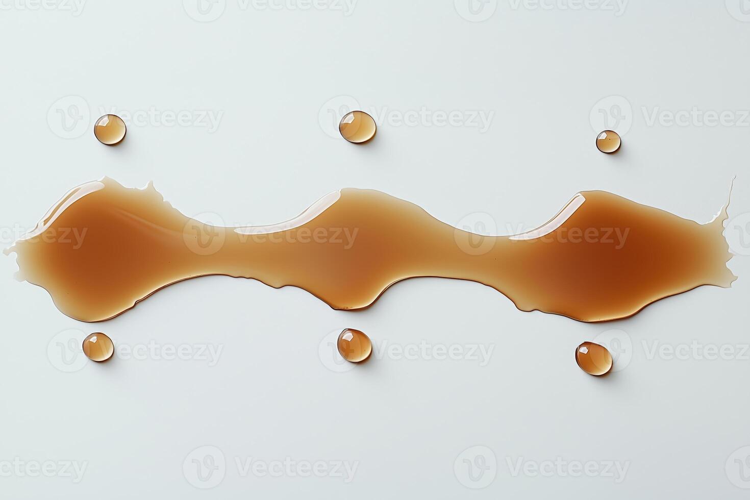 Liquid caramel spill with droplets on a white background photo