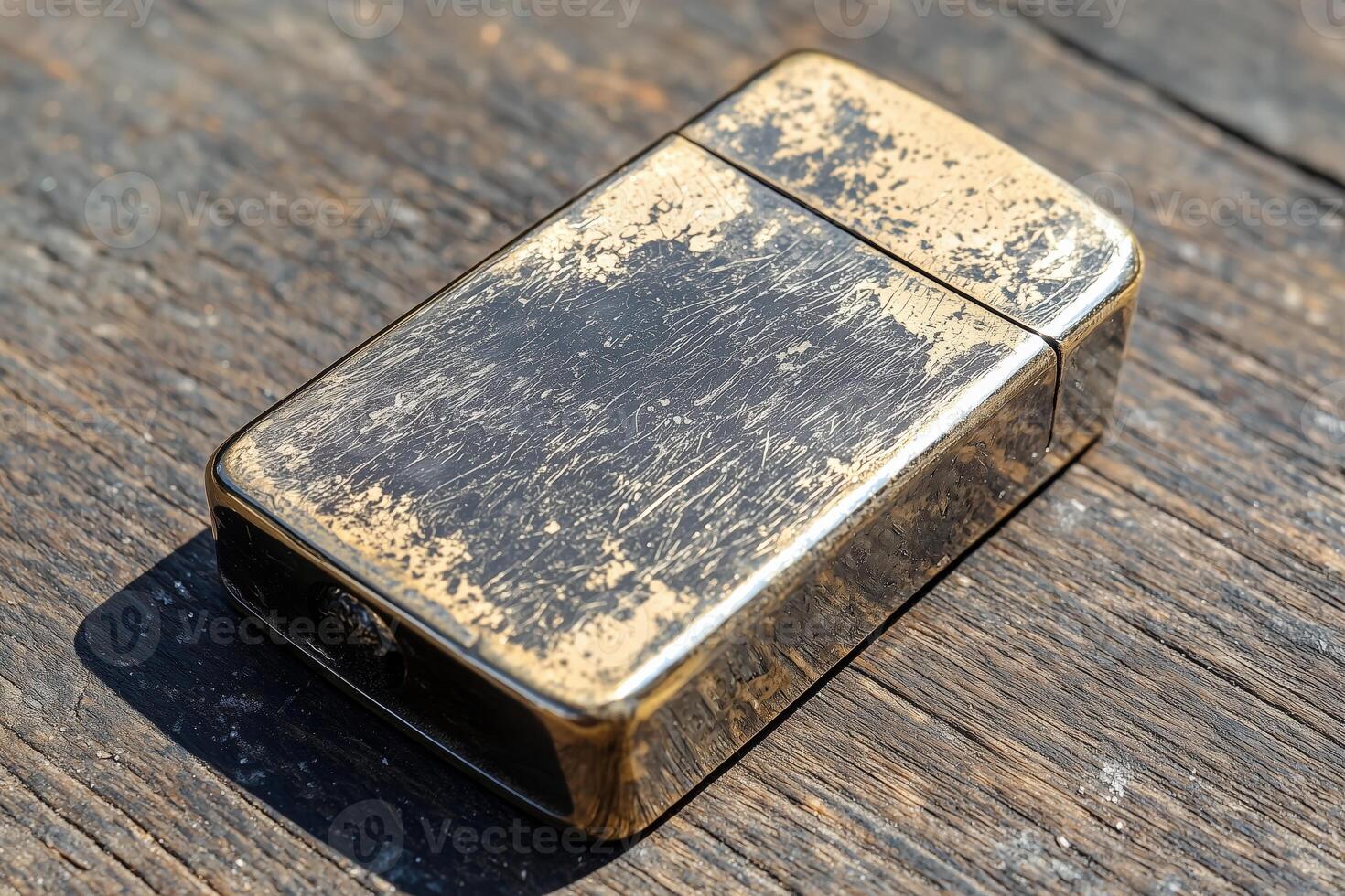 Vintage zippo lighter with distressed finish on weathered wooden surface photo