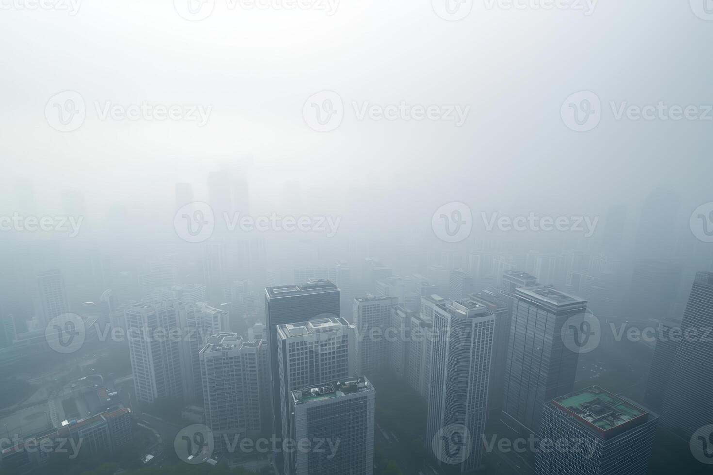 Foggy cityscape with skyscrapers and urban skyline in low visibility photo