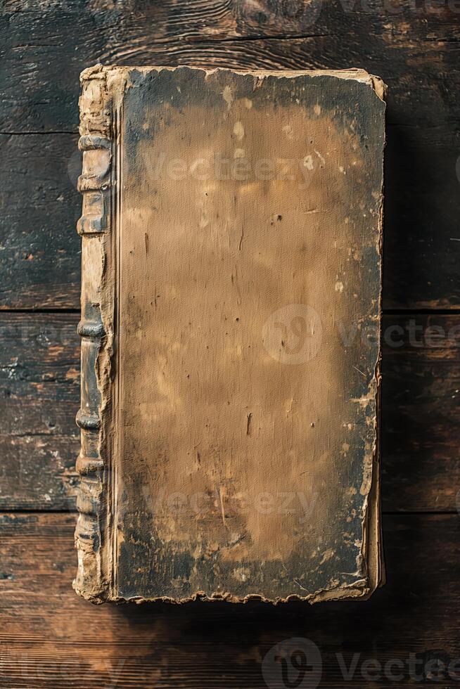 Vintage worn leather-bound book on rustic wooden table photo
