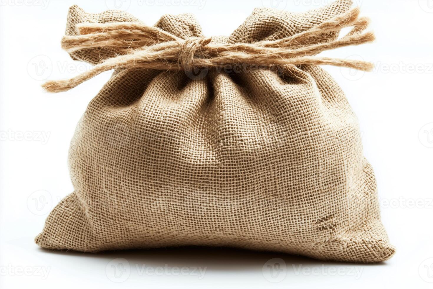 Brown burlap sack tied with rope on a white background photo