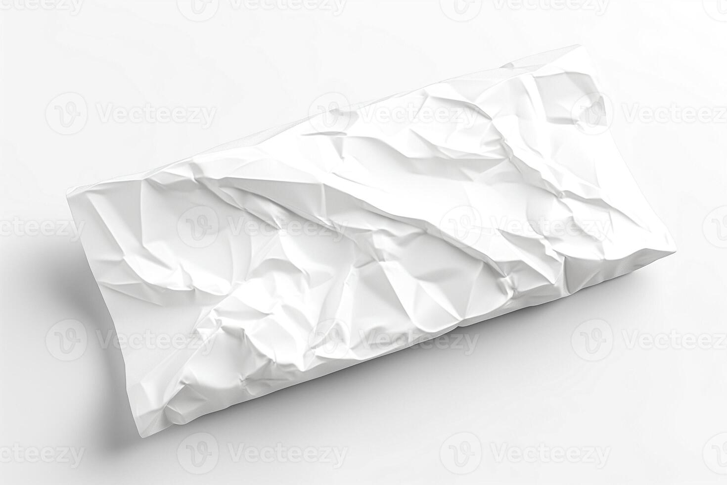 A crumpled piece of white paper, showcasing intricate folds and shadows. photo