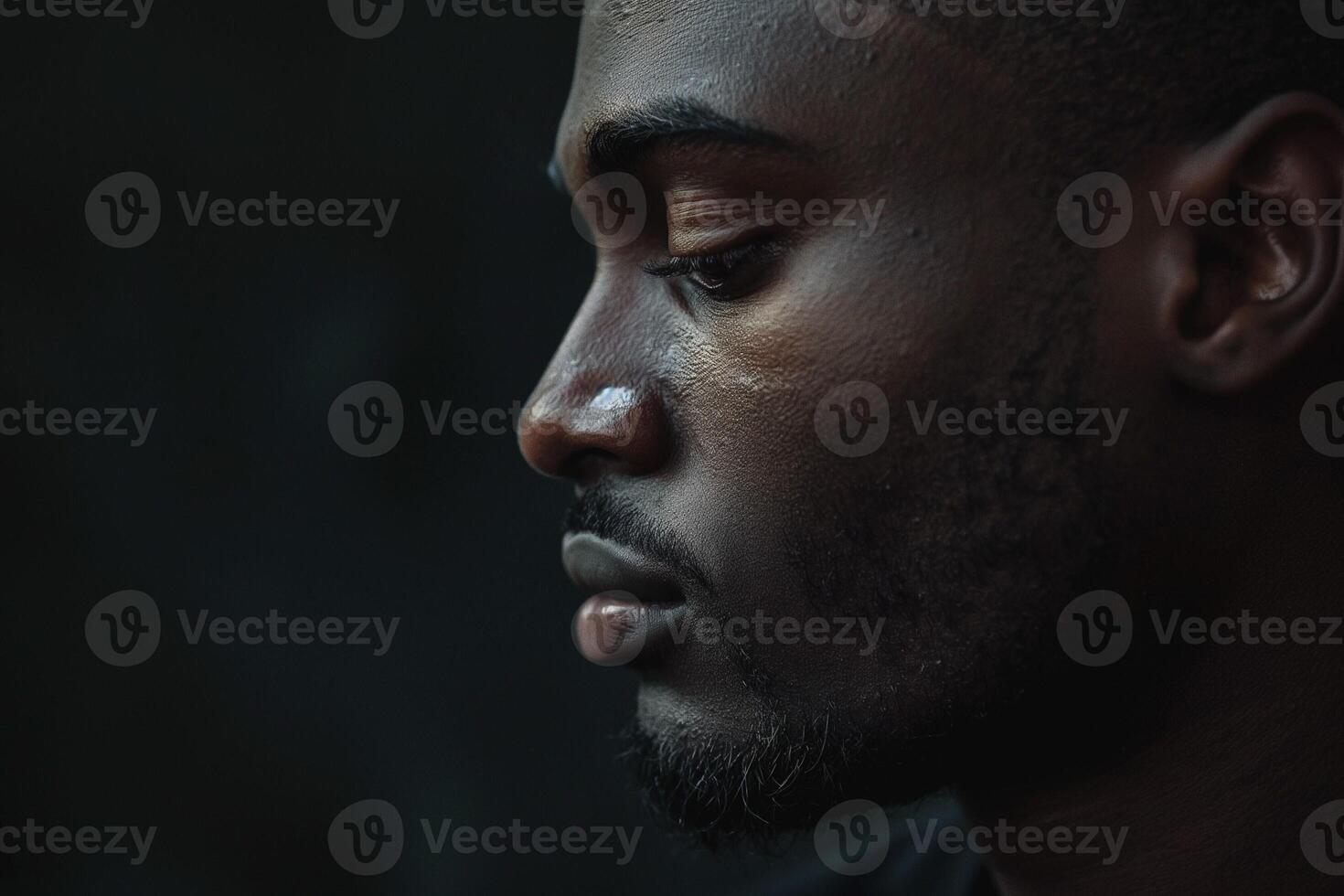 Profile of a thoughtful Black man, showcasing deep contemplation and strong facial features. photo