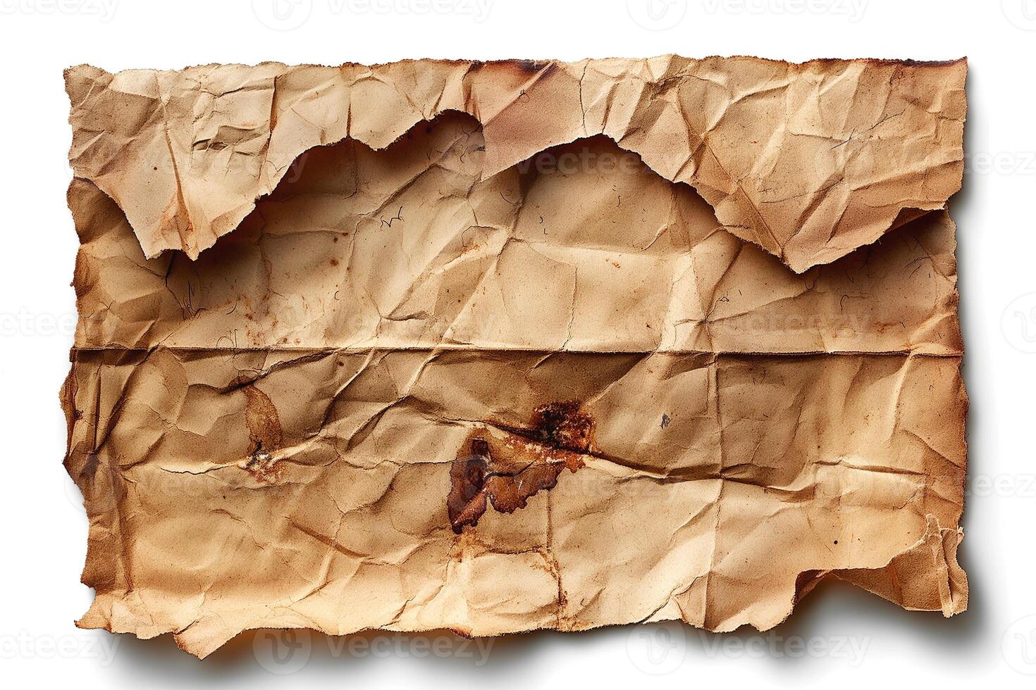 A close-up of a crumpled, aged piece of paper with brownish stains and an uneven edge, suggesting a vintage or antique quality. photo