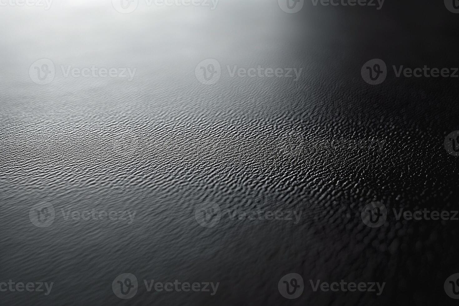 Close-up view of textured black surface with subtle ripples, creating a sophisticated and modern aesthetic. photo