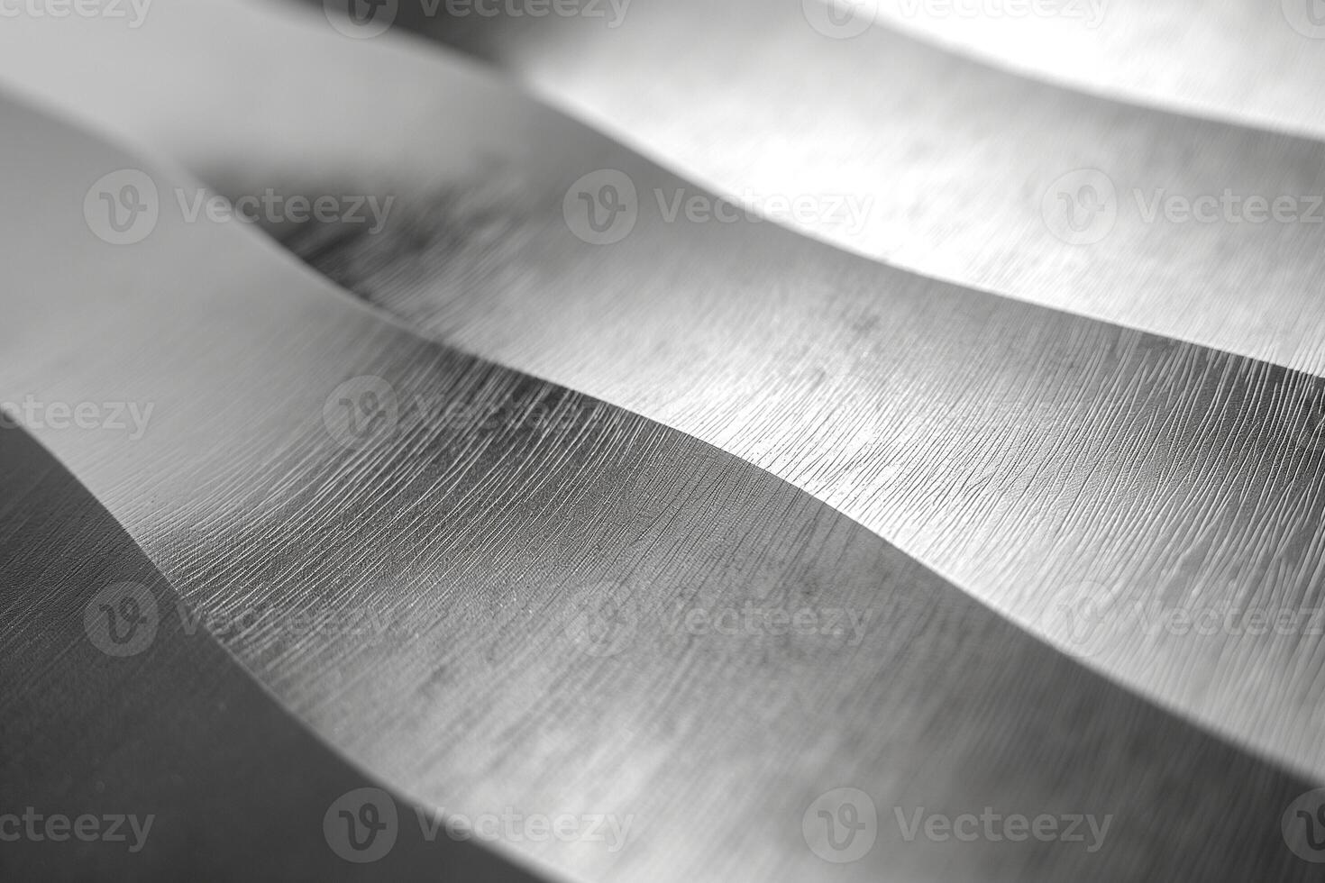Close-up of elegant silver waves showcasing brushed metal texture and light reflection. photo