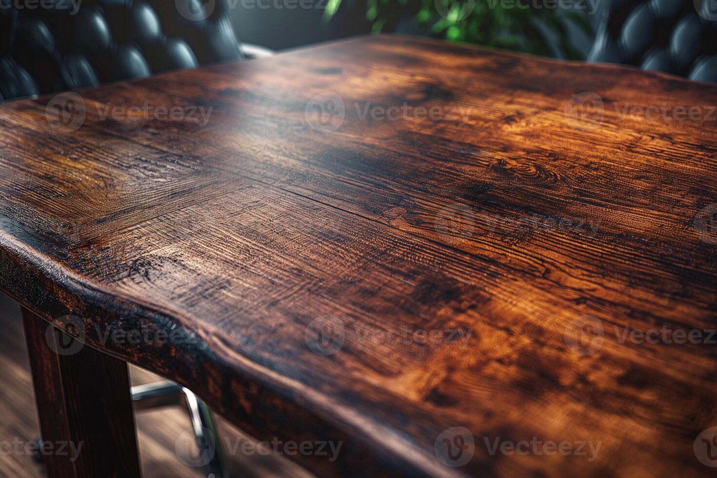 A close-up view of a beautifully crafted wooden table, showcasing its rich texture and deep, warm tones. photo