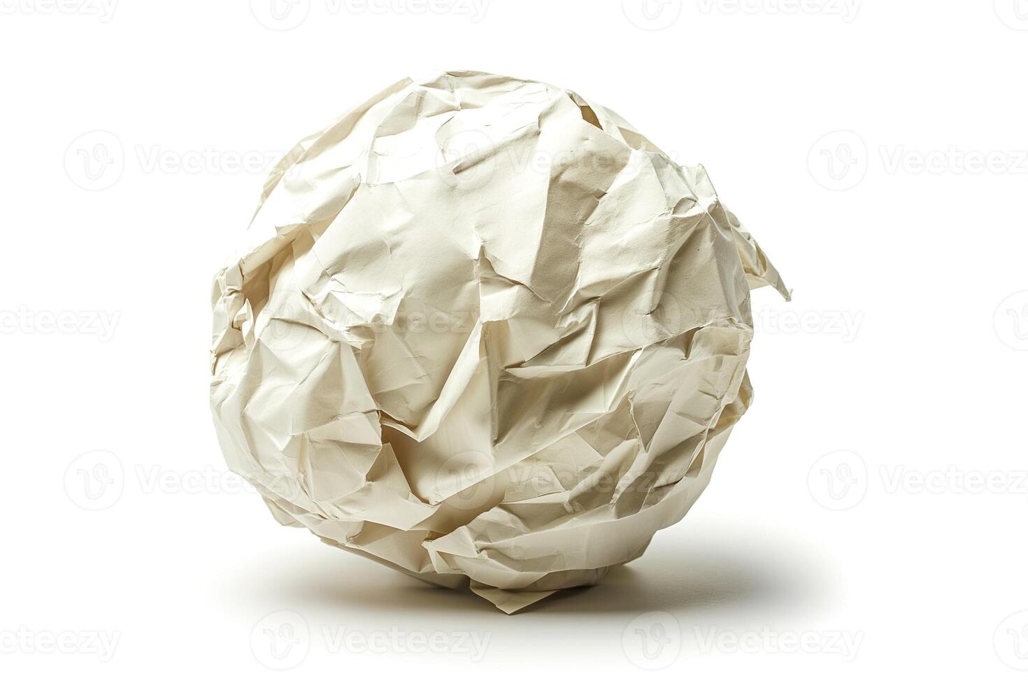 Crumbled white paper ball on a clean surface, symbolizing discarded ideas or creative processes. photo