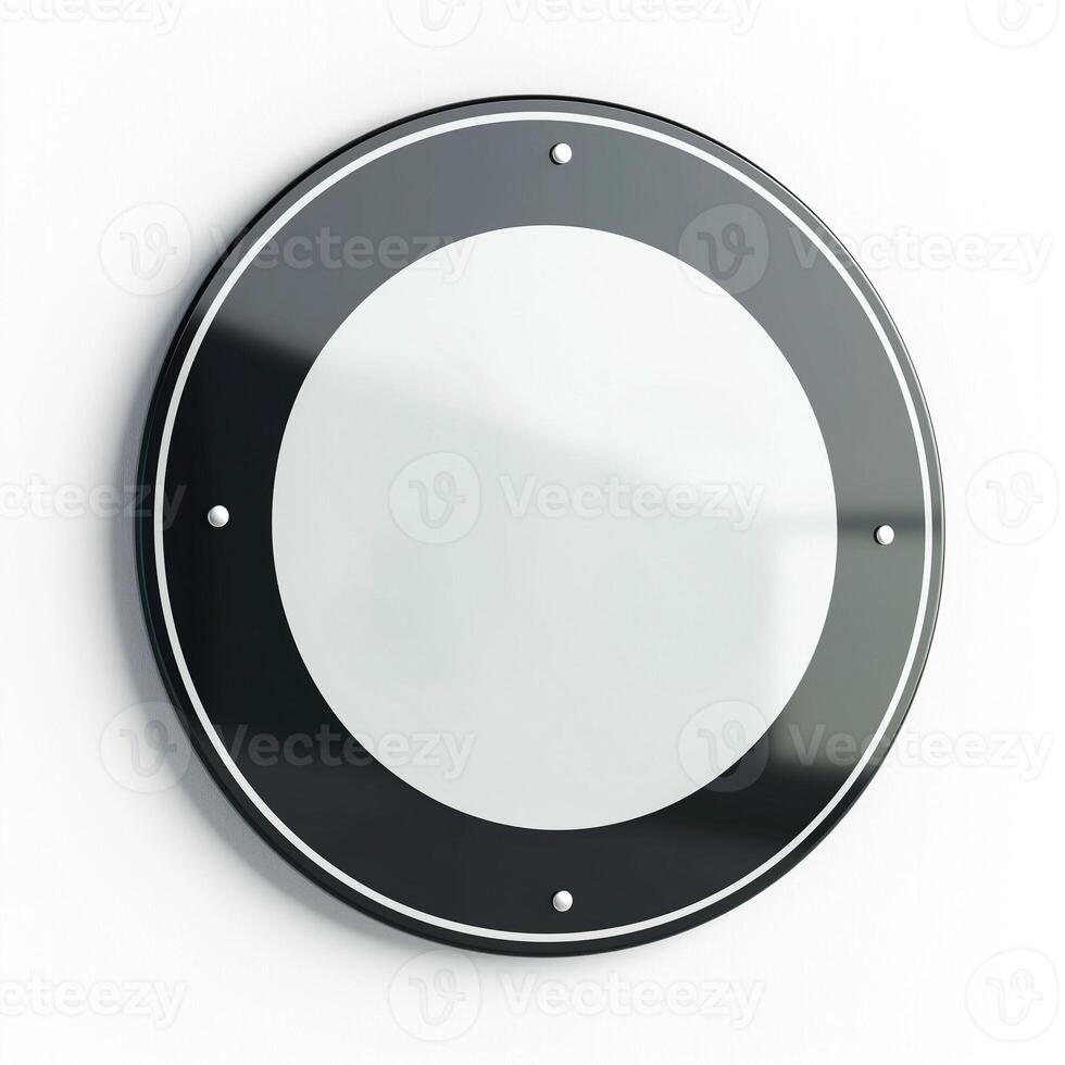 A sleek, modern circular wall mirror with a black frame, reflecting minimalistic design elements. photo