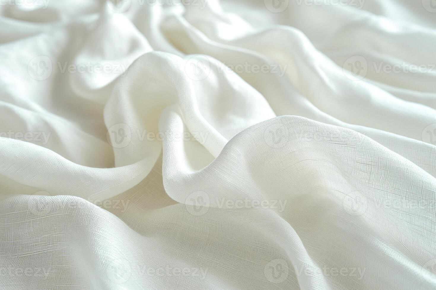 Soft and delicate white fabric draped elegantly, creating gentle waves and textures. photo