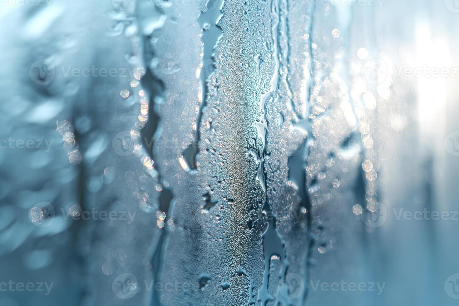 Close-up of condensation droplets on a blue glass surface, creating a serene and dreamy atmosphere. photo