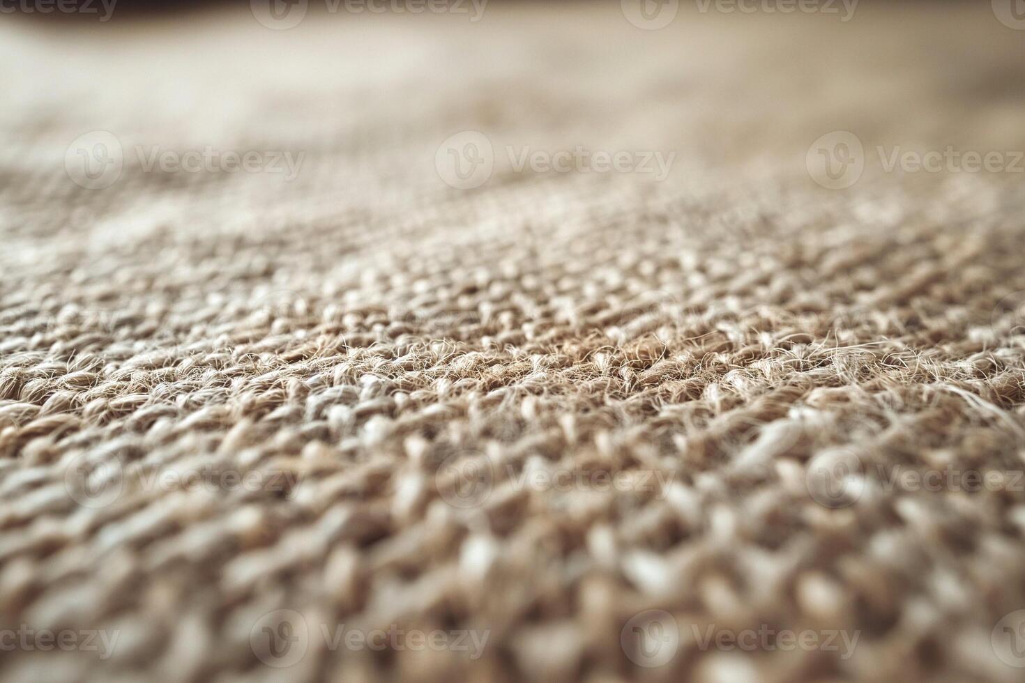 Close-up of textured jute fabric, showcasing the intricate weave and natural tones. photo