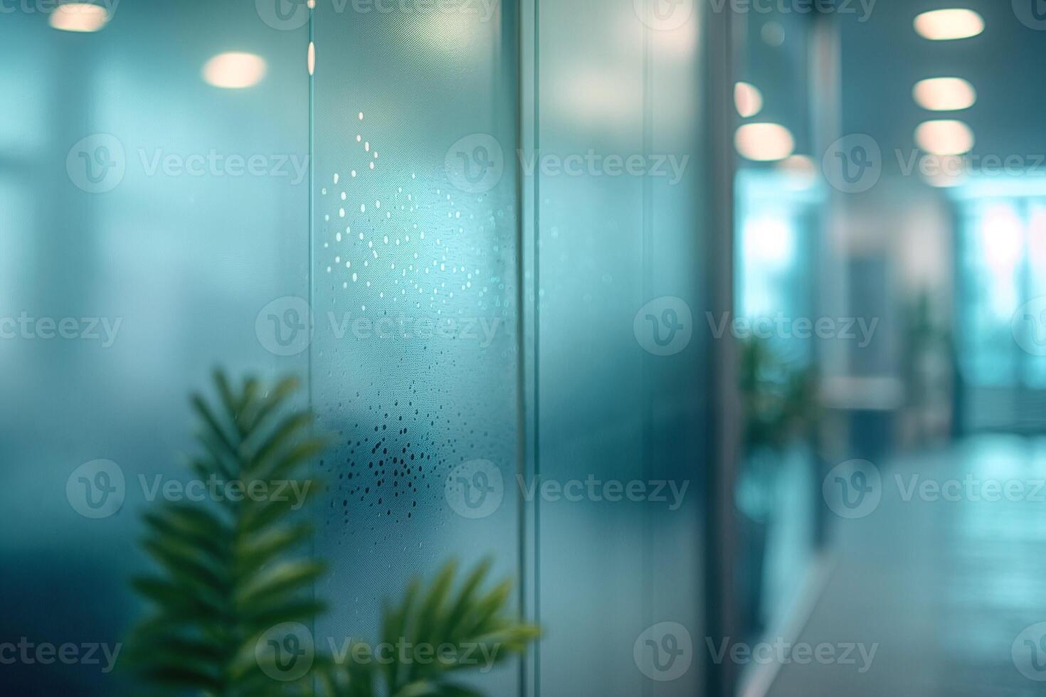 Close-up of frosted glass in a modern office setting, with plants adding a touch of nature. photo