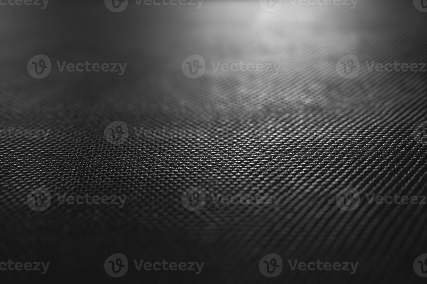 Close-up view of a dark textured surface, highlighting intricate patterns and depth. photo