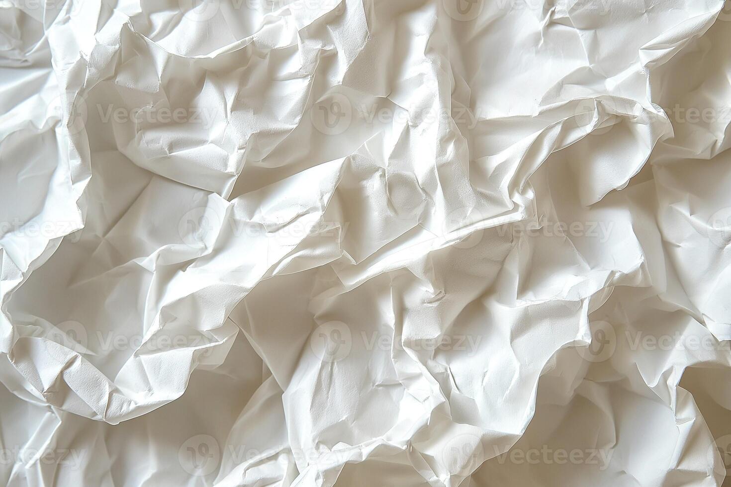 Textured close-up of crumpled white paper, showcasing intricate folds and shadows. photo