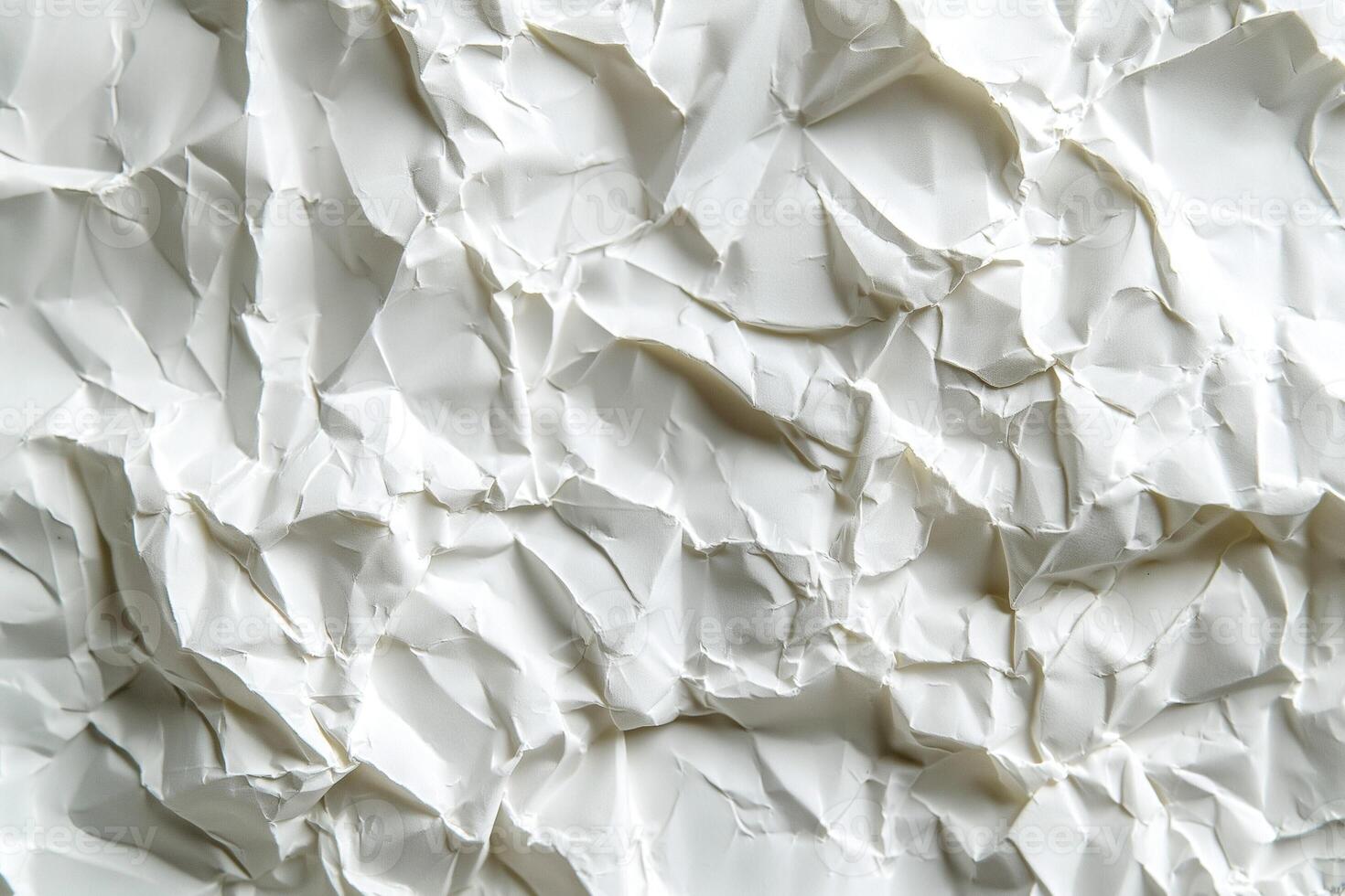 Close-up of crumpled white paper showcasing intricate textures and shadows. photo