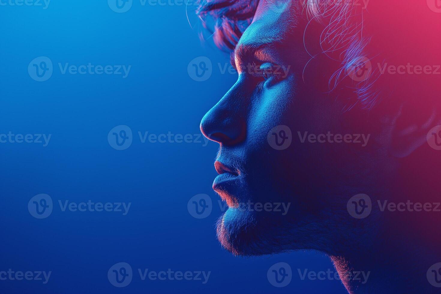 Profile of a young Caucasian male with striking blue and pink lighting, highlighting his features against a vibrant background. photo