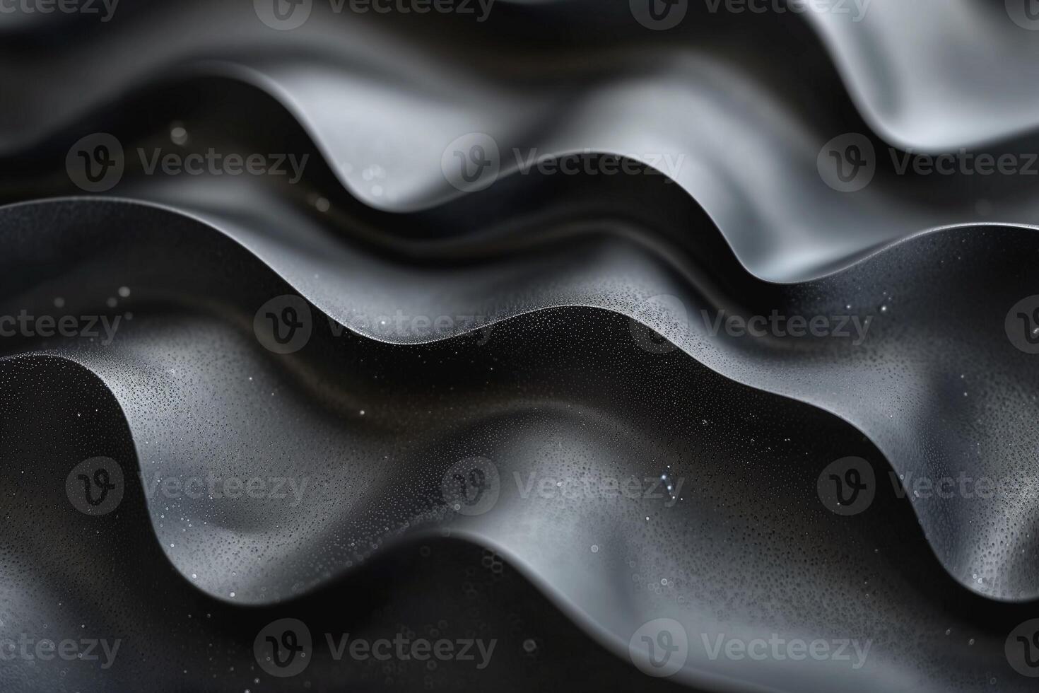 Close-up of textured black surface with soft wave patterns and fine droplets, creating a modern and sleek appearance. photo