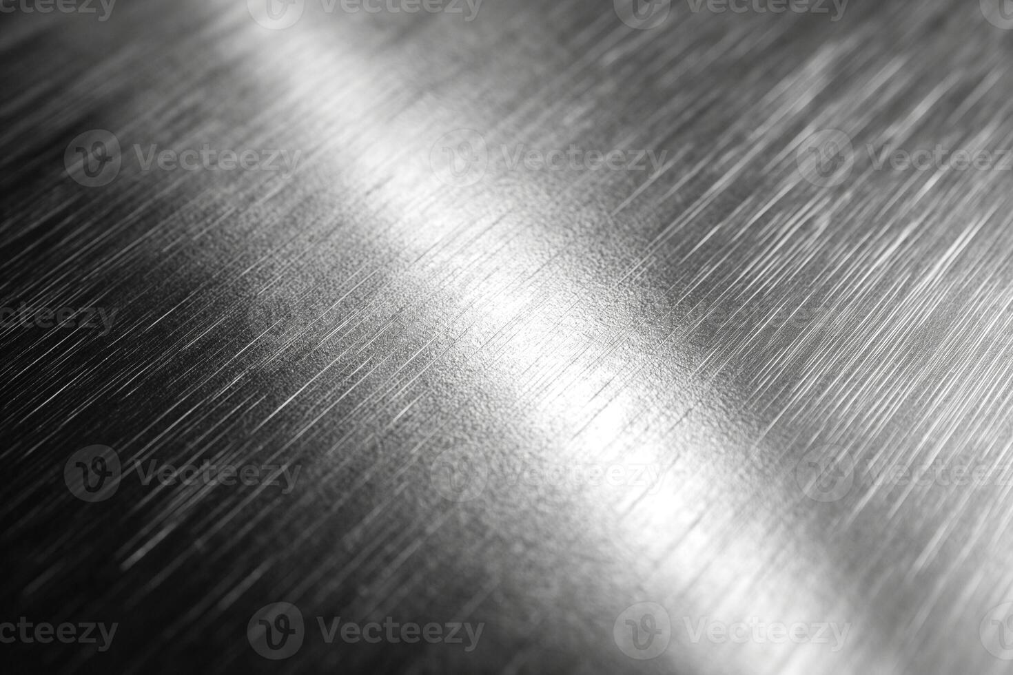 Close-up of polished stainless steel with reflective surface textures and subtle light streaks. photo