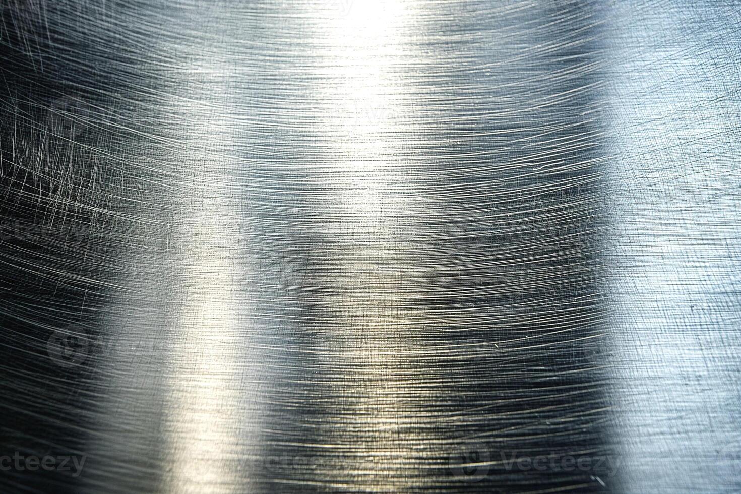 A close-up view of brushed metal, showcasing fine linear patterns and a reflective surface. photo